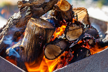A fire burns in a barbecue grill for cooking shashlik
