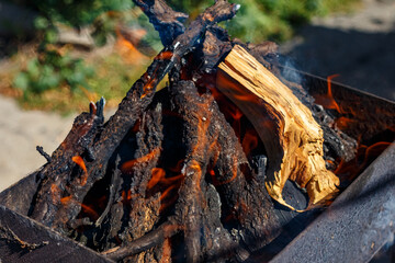 A fire burns in a barbecue grill for cooking shashlik