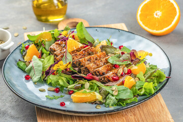 Duck salad with grilled breast and vegetables on plate, top view
