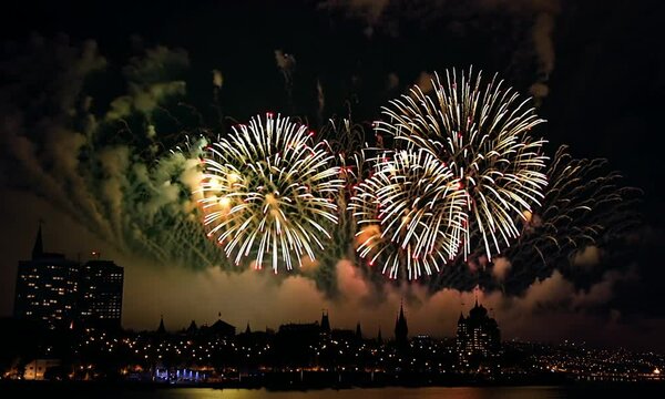 Fireworks over the city, Explosive fireworks light up the night sky over a city, creating a colorful display of lights and shapes.