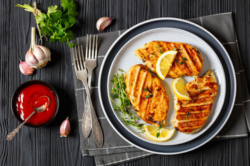 juicy grilled chicken cutlets on plate, top view