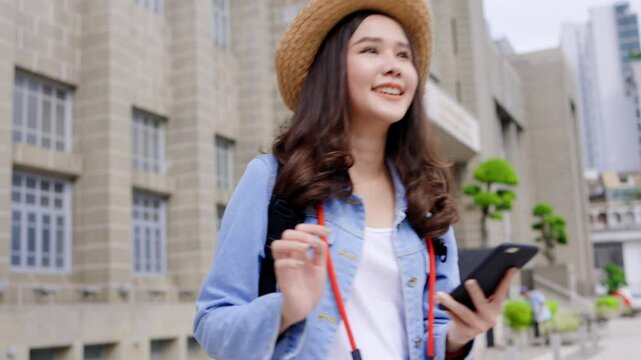 Young Asian female tourists are happy to travel during their long weekend holiday. Traveling around the city by public transportation