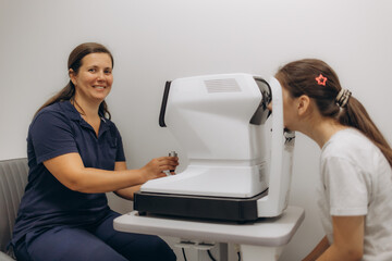 Examination of the child using a slit lamp. Microscope and focused light source. A device for...