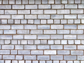 A textured white brick wall creates a versatile background with patterns and areas suitable for adding text or graphics