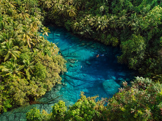 Transparent lake with crystal blue fresh water in Sulawesi, Indonesia. Aerial view