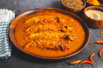 A rich, spicy Bengali dish featuring soft pabda fish simmered in a flavorful mustard-tomato gravy.