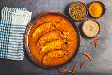 A rich, spicy Bengali dish featuring soft pabda fish simmered in a flavorful mustard-tomato gravy.