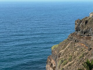 coast of the atlantic ocean with volcanic rocks and blu sky in Tenerife, Canary Islands, Spain