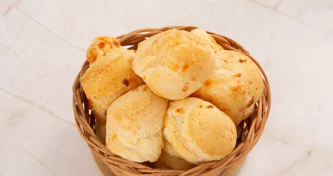 Minas Gerais cheese bread, hot, ina  wooden basket in clean brown background
