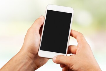 Woman's hand hold a cell phone with blank screen