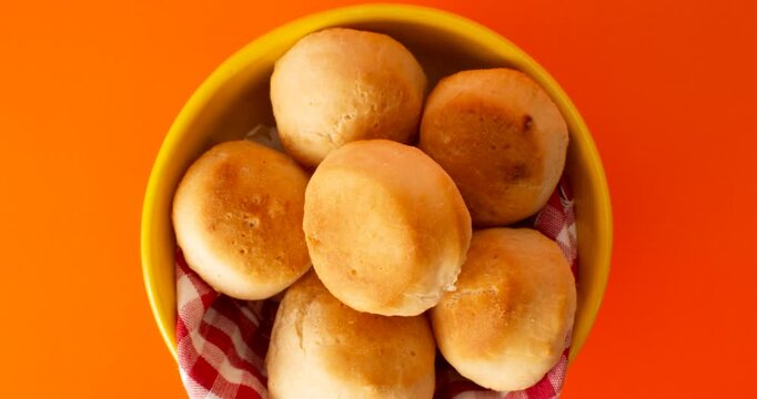 Minas Gerais cheese bread balls in a bowl and clean background front view
