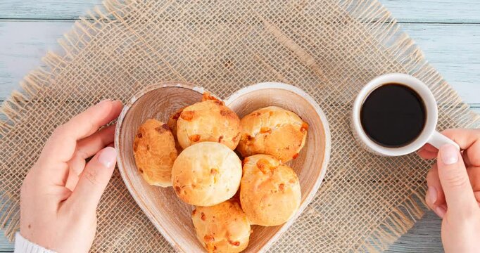 Minas Gerais cheese bread balls in a heart shapped bowl and clean background 
