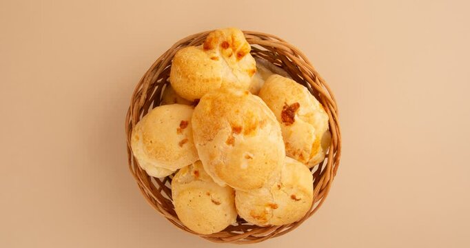 Minas Gerais cheese bread balls in a bowl and clean background front view
