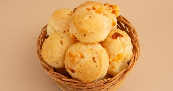 Minas Gerais cheese bread balls in a bowl and clean background front view
