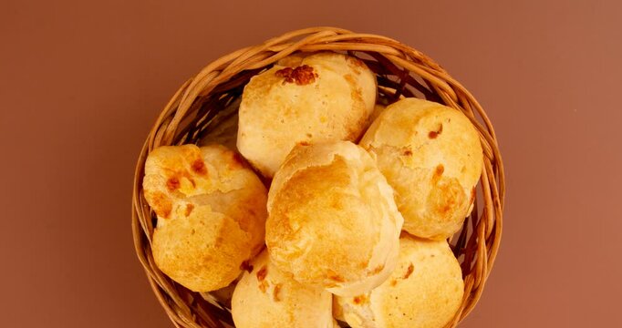 Minas Gerais cheese bread balls in a bowl and clean background front view

