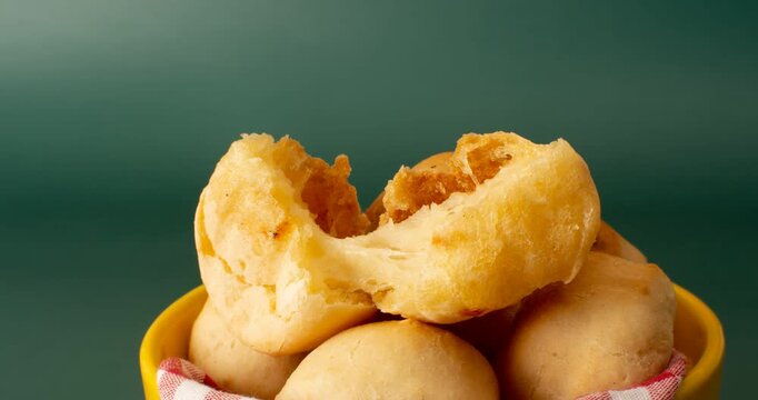 Minas Gerais cheese bread balls in a bowl and clean background front view
