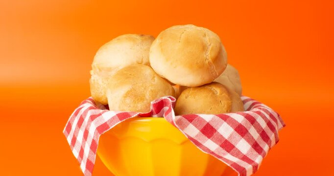 Minas Gerais cheese bread balls in a bowl and clean background front view

