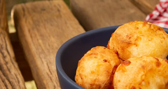 Minas Gerais cheese bread balls in a bowl and clean background front view
