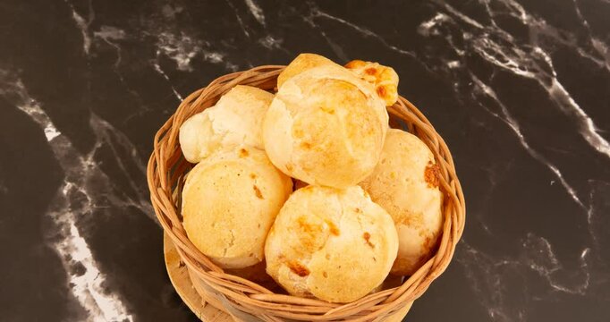 Minas Gerais cheese bread balls in a bowl and clean background front view
