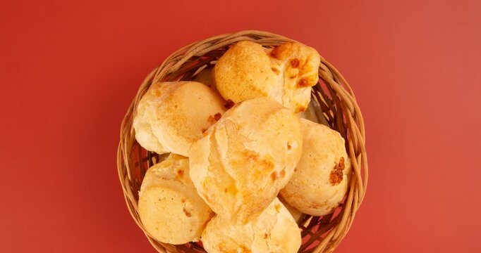 Minas Gerais cheese bread, hot, ina  wooden basket in clean brown background