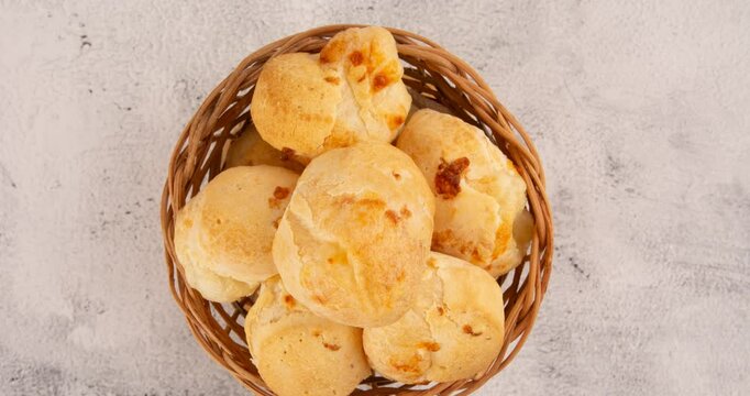 Minas Gerais cheese bread balls in a bowl and clean background front view
