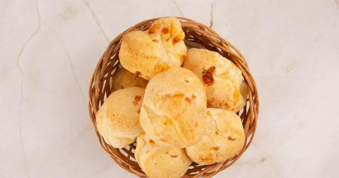 Minas Gerais cheese bread balls in a bowl and clean background front view
