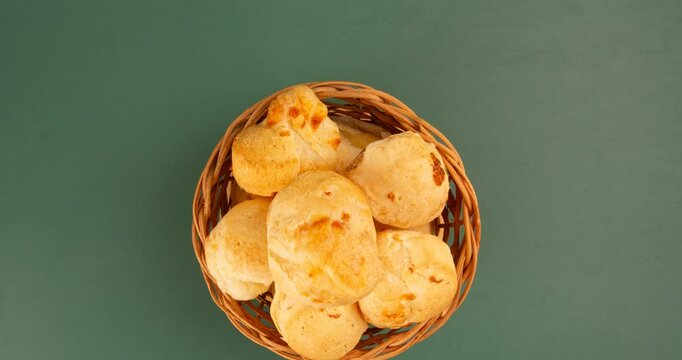 Minas Gerais cheese bread balls in a bowl and clean background front view
