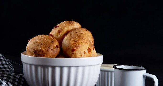 Minas Gerais cheese bread balls in a bowl and clean background front view
