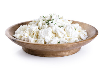 Cottage cheese in a wooden bowl isolated on white background. With clipping path.