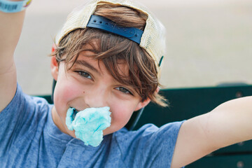 Little boy in a carnival eating candy and having fun fun spot in orlando 