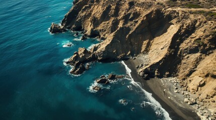 Aerial view of a rugged coastline with rocky cliffs and a secluded beach.