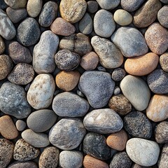 Coastal pebbles in soft tones smooth textured stone wall background