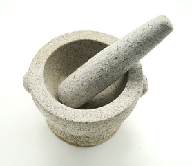 Off-white Ang Sila stone mortar with pestle, top view, isolated on white background.