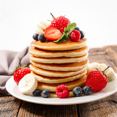 pancake stack, banana, strawberry, raspberry, blueberry fruits