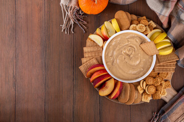 Pumpkin Fluff, Pumpkin spice mousse dip with cookies, fruits, crackers on appetizer serving board...