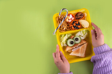 Halloween funny kids food, school lunch box with crackers, monster healthy cheesy sandwich, cookies...