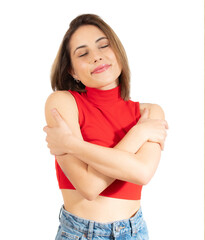 Portrait of a pretty young woman in casual clothes hugging herself over transparent background....
