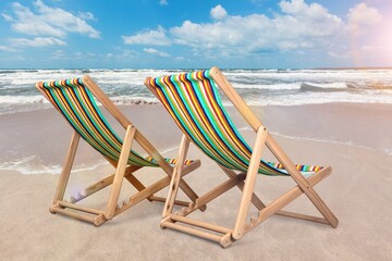 tropical beach with a turqouse ocean and relaxing beach chair