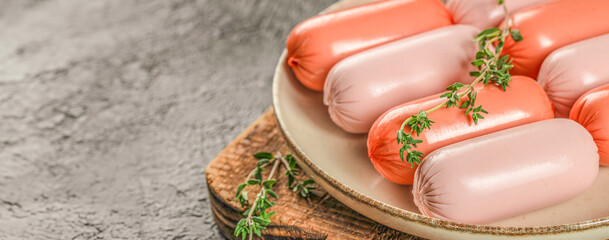 Fresh raw sausages on a wooden board, top view, Ingredients for hot dogs