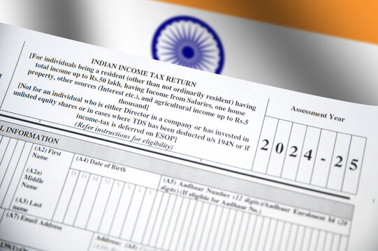 Indian Income Tax Return form with Waving flag in the backdrop.