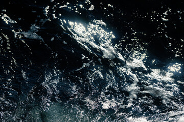 Waves and sea foam at the seashore. Natural background.