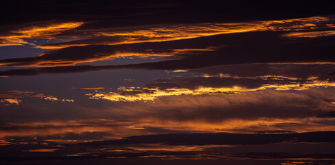 Sunset sky with orange clouds. Nature background.