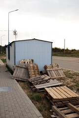 a big amount of wooden construction pallets on the ground near construction site