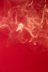 Curls of smoke on a red background