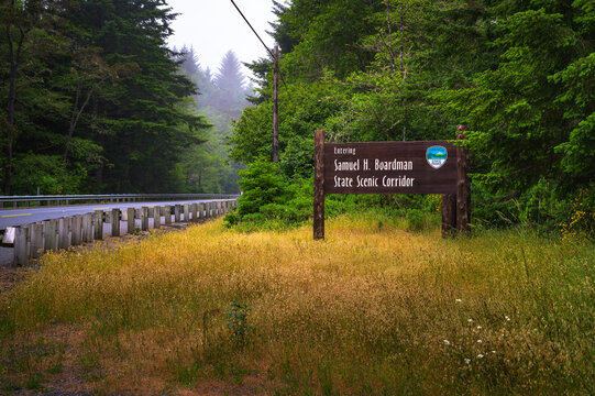 Brookings, Oregon, USA - June 06, 2023 : Road leading into Samuel H. Boardman State Scenic Corridor in Oregon with welcome sign and greenery.