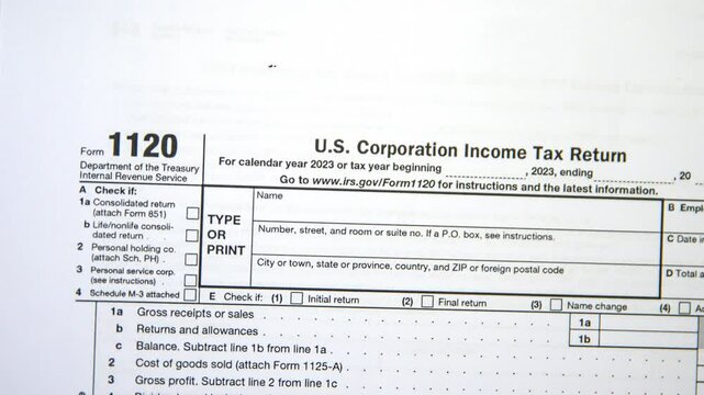 U.S. Corporation income tax return form with an American flag in the backdrop. 1120 form footage with us flag