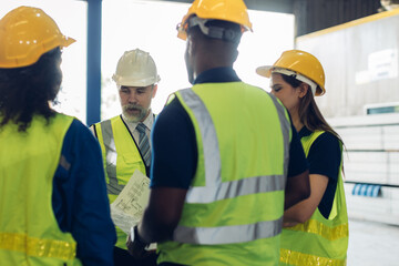 The Manager are taking a safety briefing before work. Implementation of safety culture at Factory. Factory Meeting:  Chief Engineer Talking to Colleagues Before Work Day in Heavy Industry