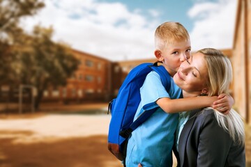 Mother accompanies small child to school