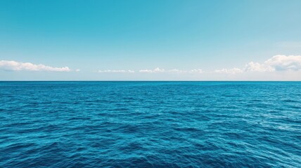 Obraz premium A serene view of a calm ocean under a clear blue sky, perfect for relaxation and tranquility.