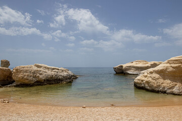 Beautiful quaint empty beach with clear waters and chalk rocks